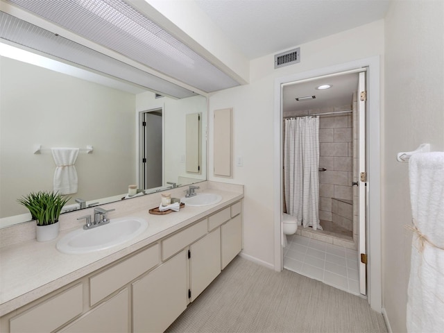 bathroom with vanity, toilet, and curtained shower