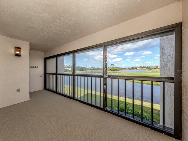 unfurnished sunroom with a water view