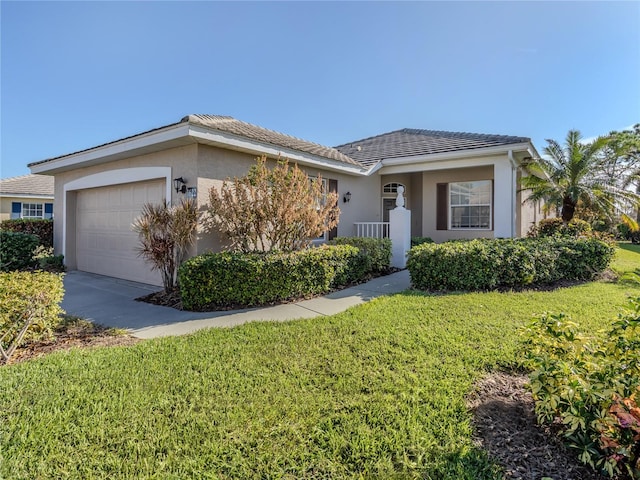 ranch-style house featuring a front lawn and a garage