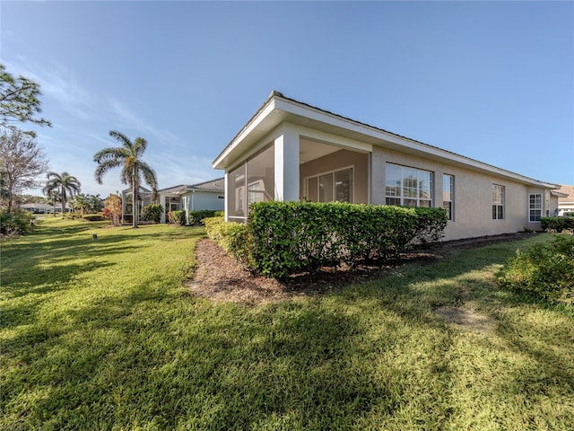 view of property exterior with a yard