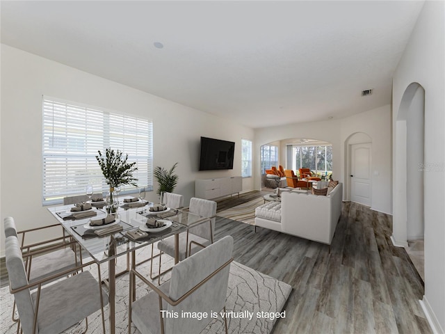 dining space with dark wood-type flooring