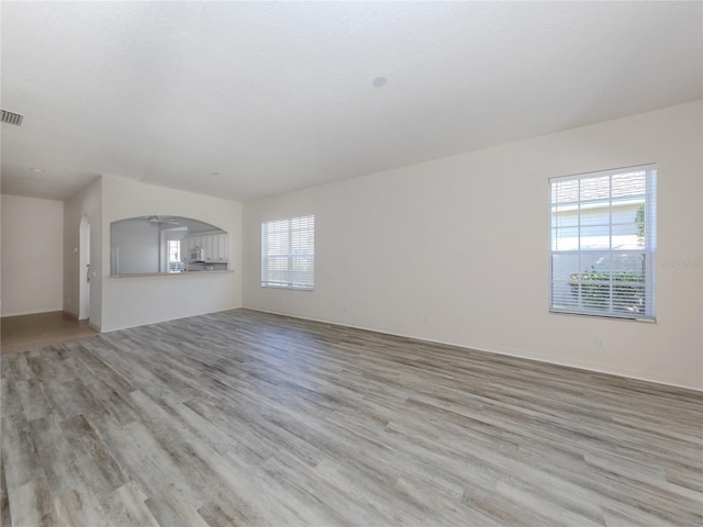 unfurnished living room with light hardwood / wood-style flooring and a wealth of natural light