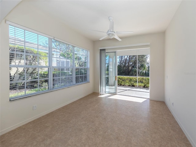 tiled spare room featuring ceiling fan