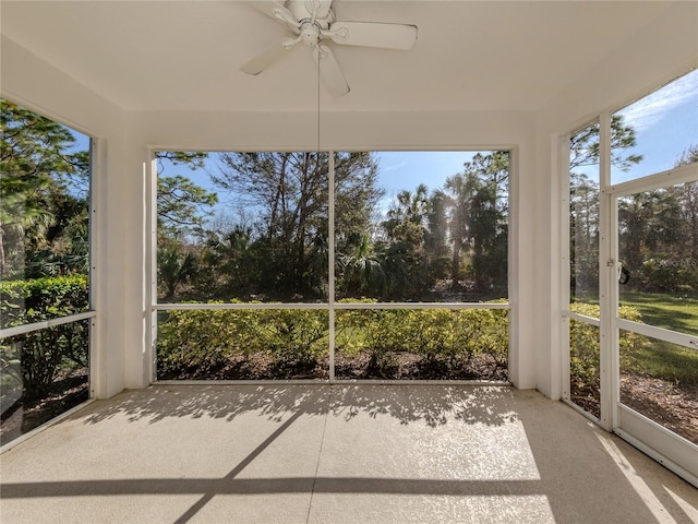 unfurnished sunroom featuring ceiling fan