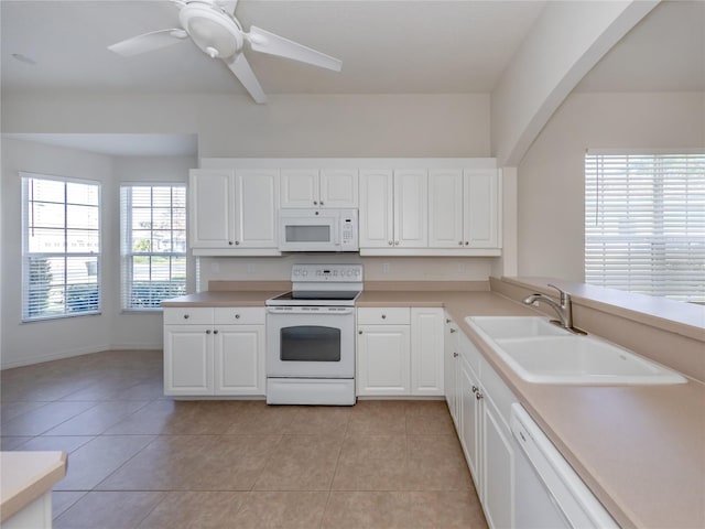 kitchen with sink, light tile patterned flooring, white cabinets, white appliances, and ceiling fan