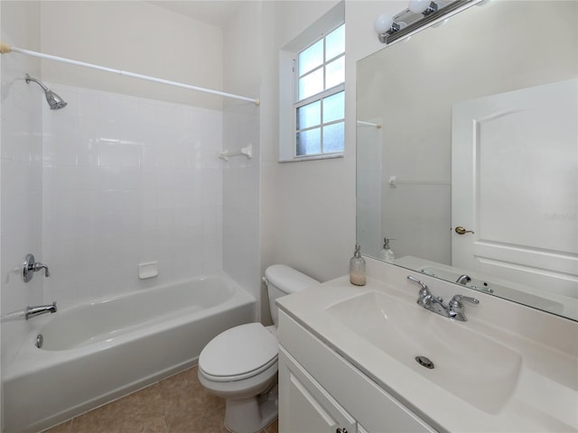 full bathroom featuring vanity, tiled shower / bath combo, toilet, and tile patterned floors