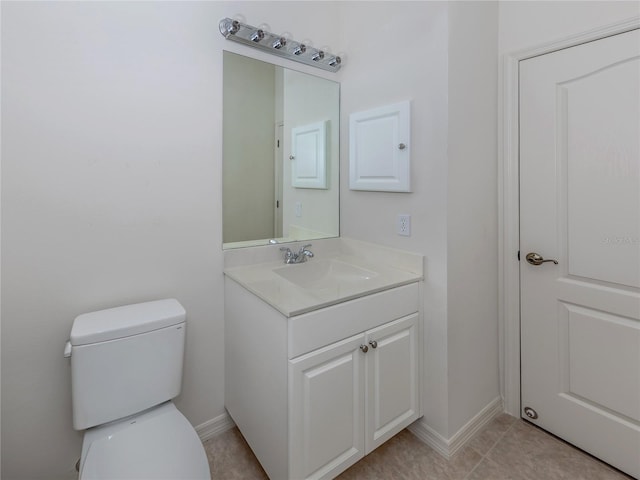 bathroom with vanity, toilet, and tile patterned floors