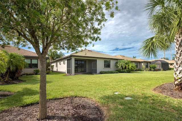 back of house with a lawn