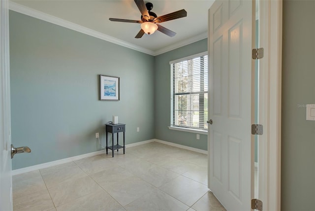 empty room with ornamental molding, ceiling fan, and light tile patterned flooring