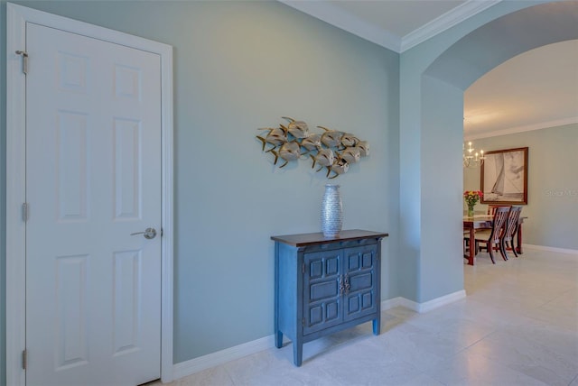 hall with an inviting chandelier and crown molding