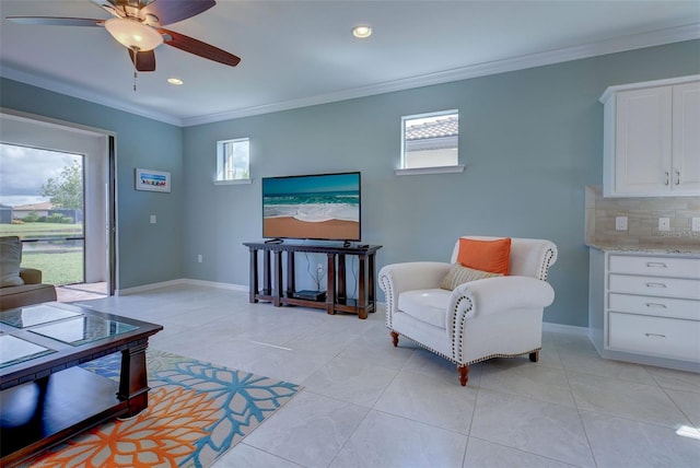 tiled living room featuring ornamental molding, ceiling fan, and plenty of natural light