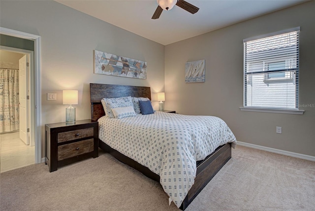 bedroom with light carpet, ceiling fan, and ensuite bathroom