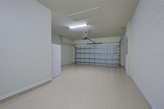 garage featuring a garage door opener and white fridge