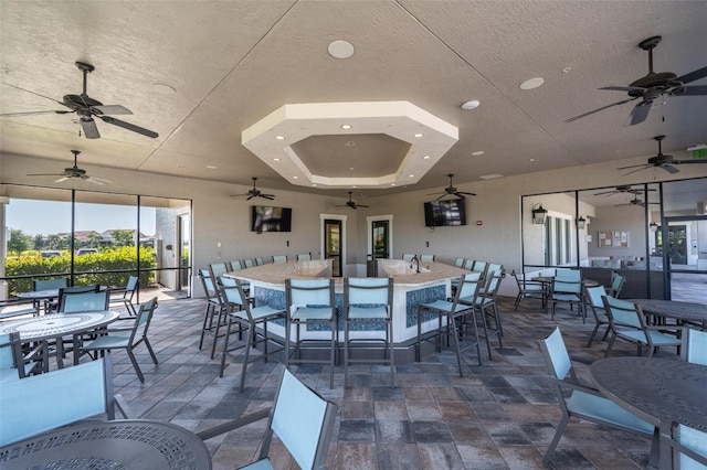 dining area with a textured ceiling and a tray ceiling