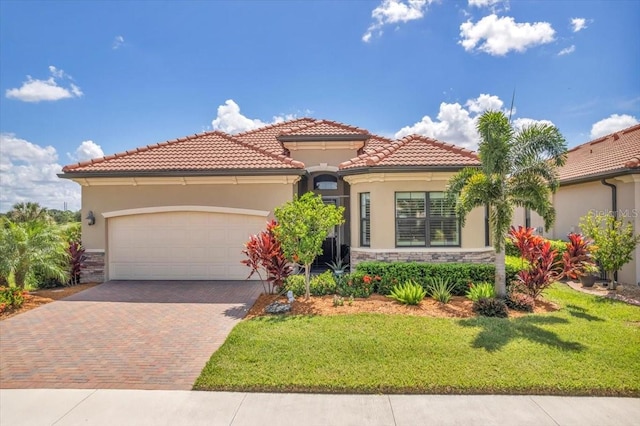 mediterranean / spanish-style house featuring a front lawn and a garage