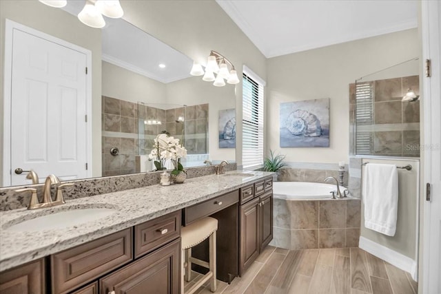 bathroom with vanity, crown molding, and shower with separate bathtub