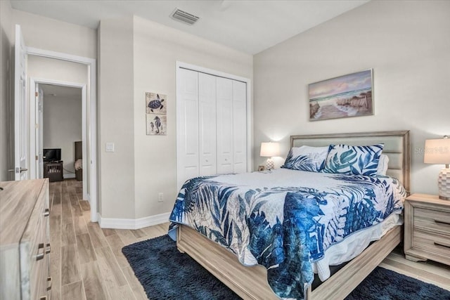 bedroom featuring a closet and light wood-type flooring