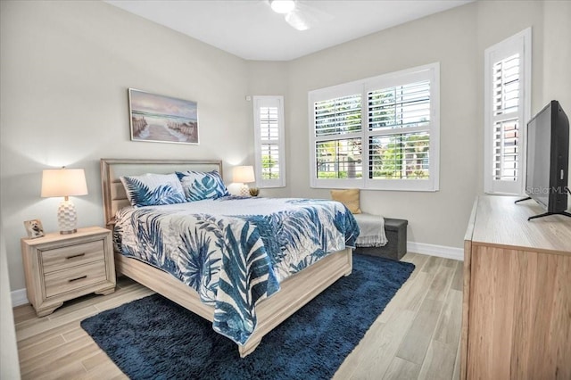 bedroom featuring light wood-type flooring and ceiling fan