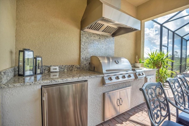 view of patio / terrace with area for grilling, a grill, and glass enclosure