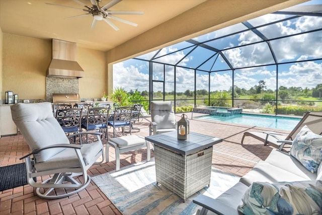 view of patio with ceiling fan, grilling area, and glass enclosure