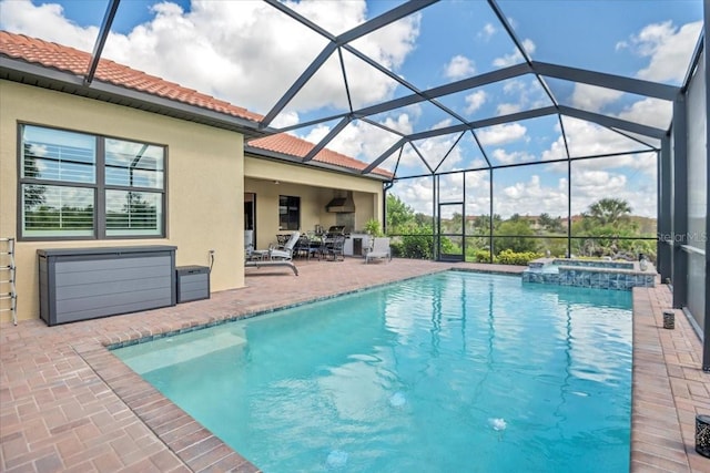 view of pool featuring a patio area, an in ground hot tub, and glass enclosure