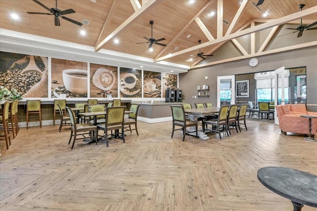 dining area with beamed ceiling, wood ceiling, light parquet floors, and high vaulted ceiling