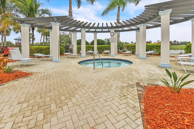 view of pool with a hot tub, a water view, a patio area, and a pergola