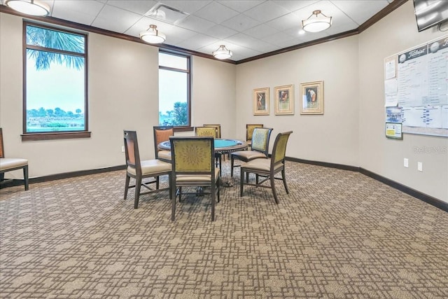 carpeted dining space with ornamental molding