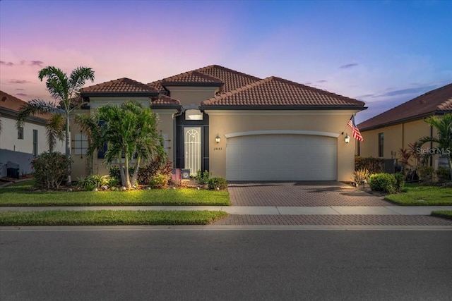 mediterranean / spanish-style home featuring a garage