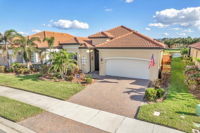 mediterranean / spanish home with a front lawn and a garage