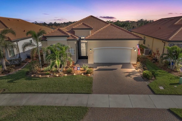 mediterranean / spanish-style home with a garage