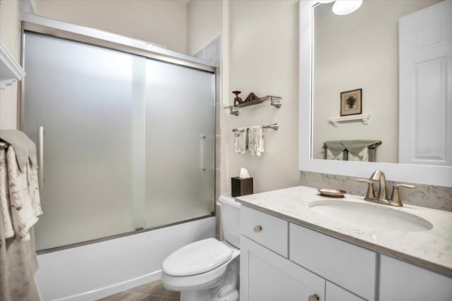 full bathroom with vanity, toilet, tile patterned floors, and combined bath / shower with glass door