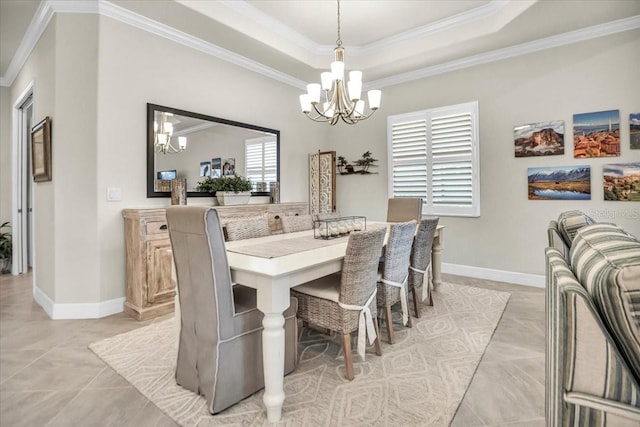 tiled dining room with a notable chandelier, a raised ceiling, and crown molding