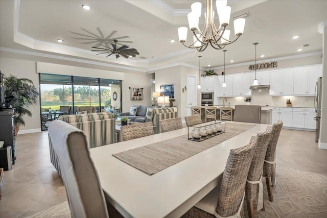 dining room featuring crown molding, a raised ceiling, and ceiling fan with notable chandelier