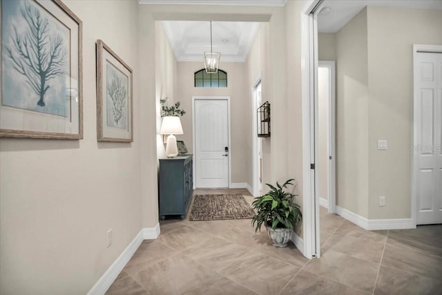 entrance foyer with crown molding and a tray ceiling