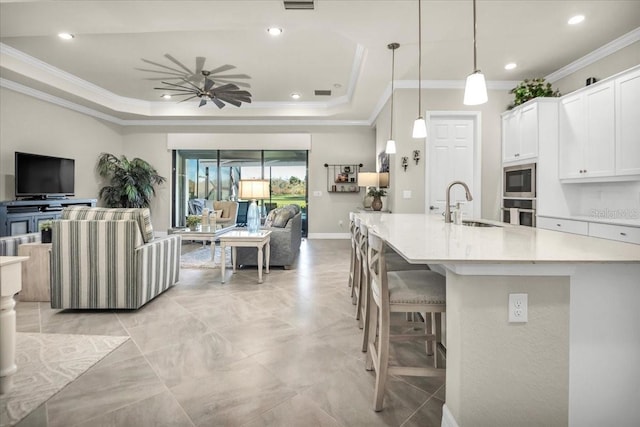 kitchen featuring crown molding, white cabinets, decorative light fixtures, and ceiling fan