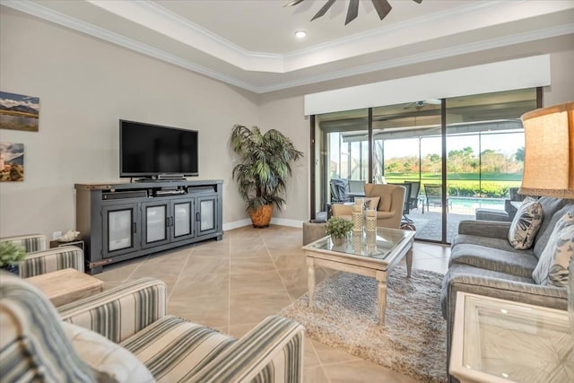 tiled living room with crown molding, a raised ceiling, and ceiling fan