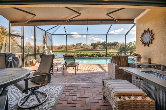 view of patio with glass enclosure and a grill