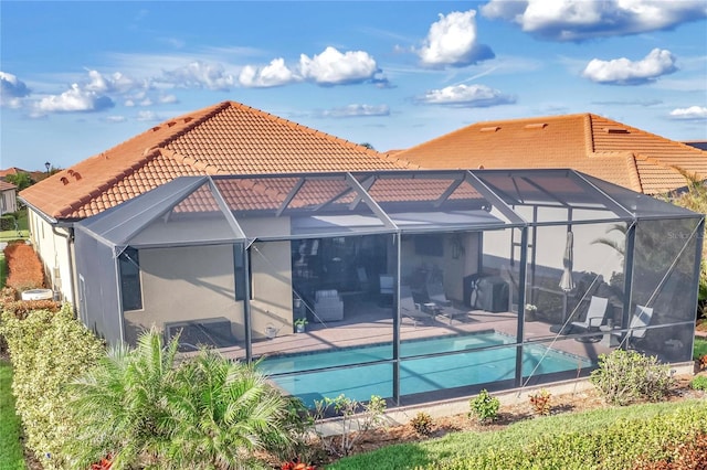 back of property featuring a patio area and a lanai