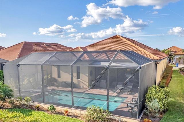 rear view of property featuring a lanai