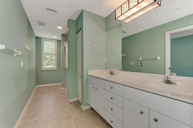 bathroom with tile patterned floors, a shower with shower door, and vanity