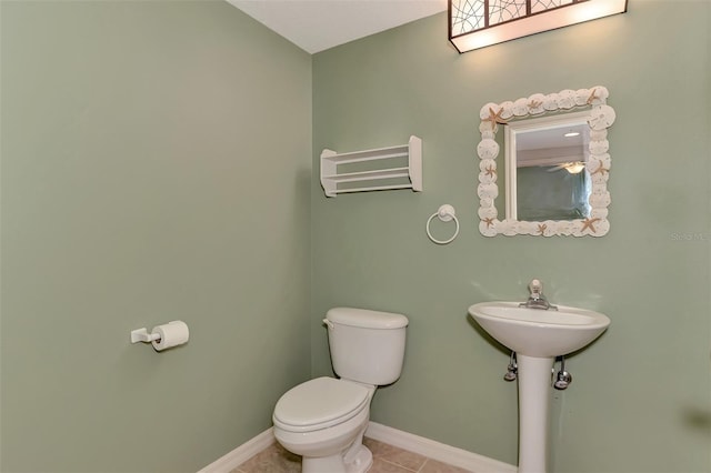 bathroom with tile patterned flooring and toilet