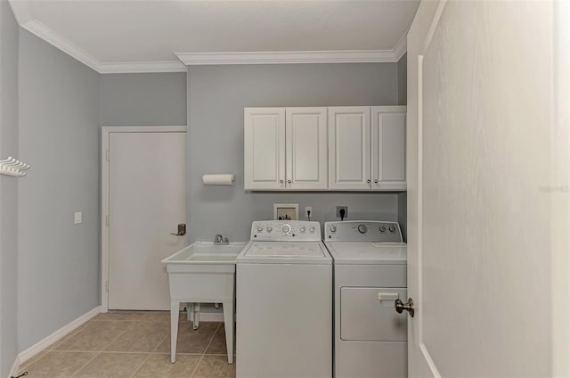 laundry area featuring cabinets, washer and clothes dryer, light tile patterned floors, and ornamental molding