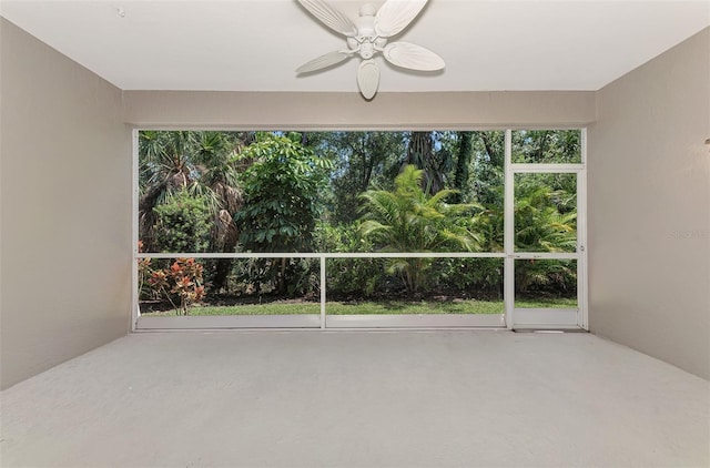 unfurnished sunroom with ceiling fan and a healthy amount of sunlight