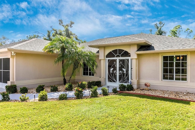 view of exterior entry featuring a yard