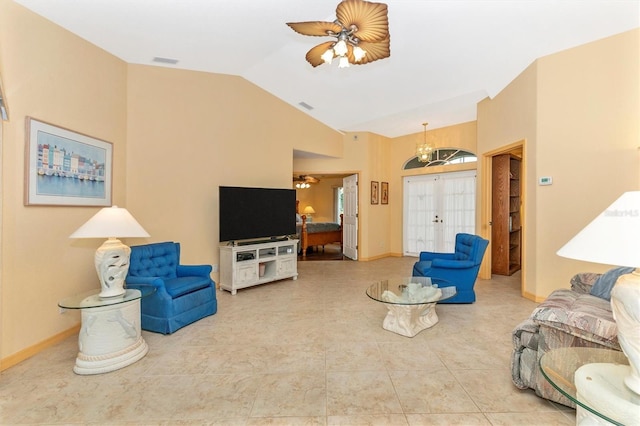 living room with ceiling fan with notable chandelier, light tile patterned flooring, and vaulted ceiling