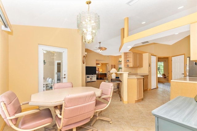 dining space with ceiling fan with notable chandelier, lofted ceiling, and light tile patterned floors