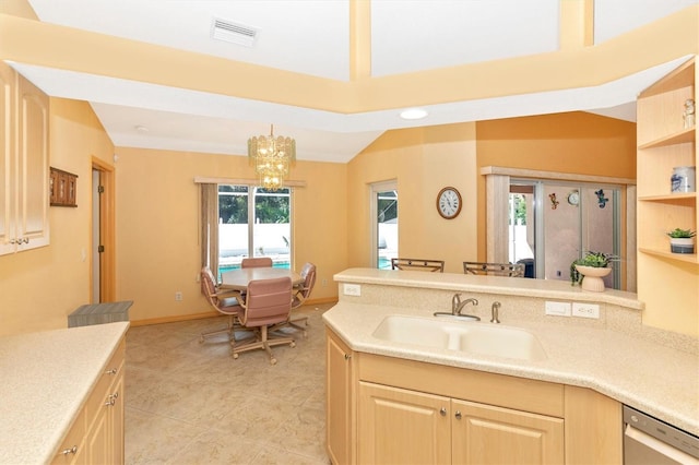 kitchen featuring sink, stainless steel dishwasher, decorative light fixtures, an inviting chandelier, and vaulted ceiling