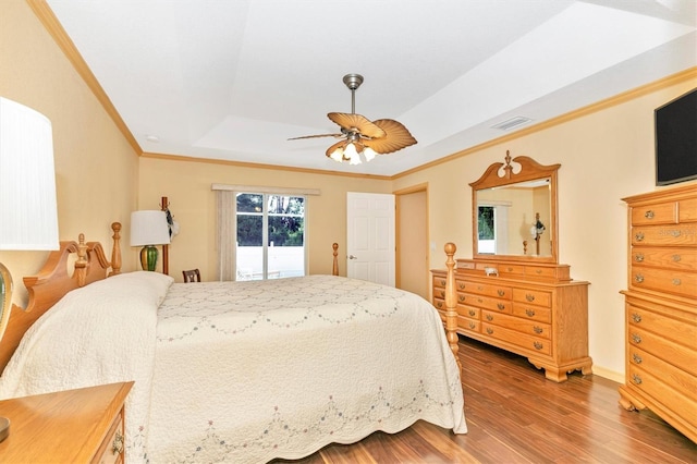 bedroom with crown molding, wood-type flooring, a tray ceiling, ceiling fan, and access to outside