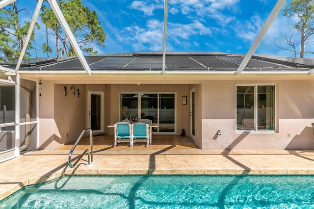 view of swimming pool featuring a lanai and a patio area